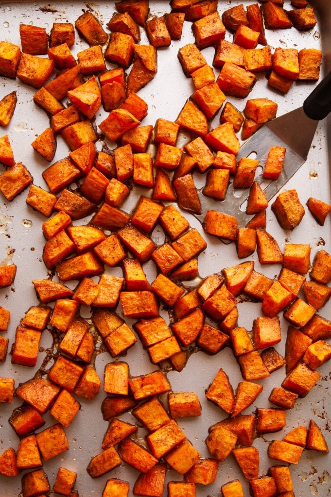 Roasted sweet potatoes on a baking sheet.