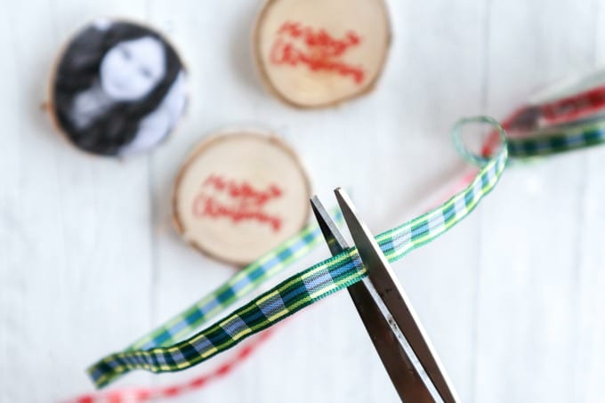 Close up of Christmas ribbon being cut by scissors.
