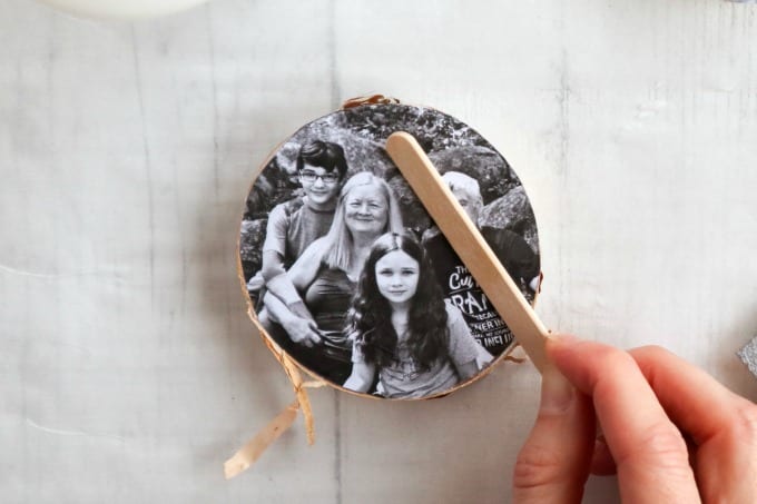 Instructions for creating this wood slice photo ornament craft using mod podge.