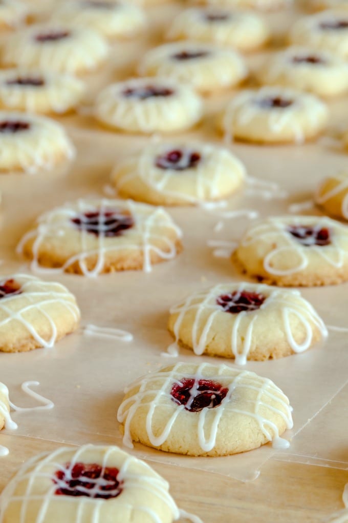 Best Thumbprint Cookie Recipe
Close up of raspberry filled cookies drizzled with icing.
