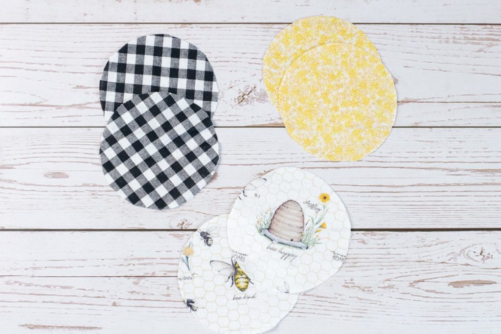 Mason Jar Lid Coasters DIY project:
step by step instructions for making Mason Jar Lid Coasters with mason jar lids, paint, fabric, and cork.