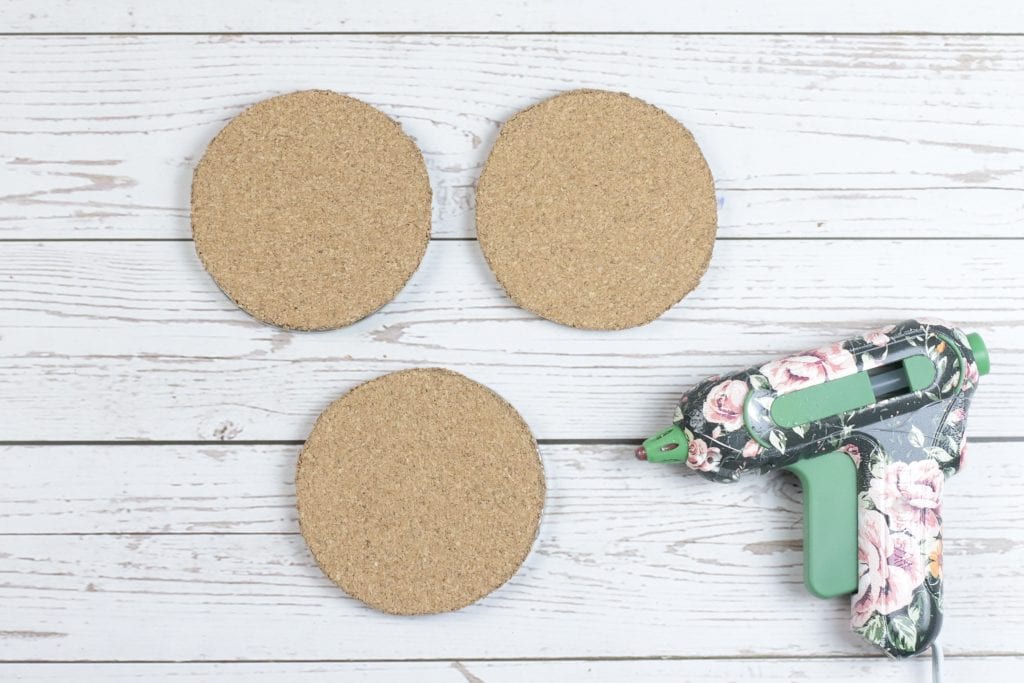 Mason Jar Lid Coasters DIY project:
step by step instructions for making Mason Jar Lid Coasters with mason jar lids, a glue gun, paint, fabric, and cork.