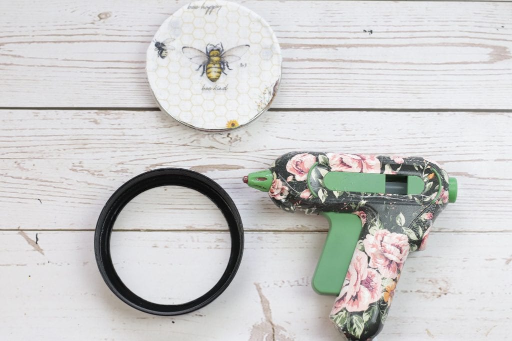 Mason Jar Lid Coasters DIY project:
step by step instructions for making Mason Jar Lid Coasters with mason jar lids, paint, fabric, cork and a hot glue gun.