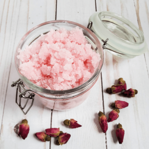 Rose sugar scrub in a glass jar.