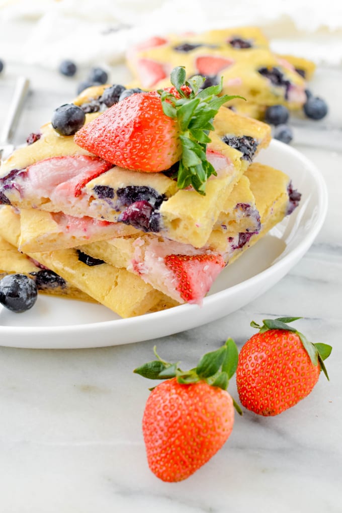 Sheet Pan Pancakes with fruit on a white plate.