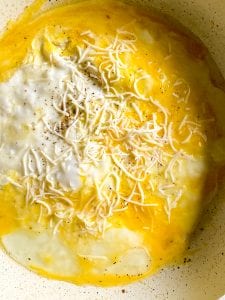 How to Make egg quesadillas: cook the egg and top with half the cheese.
