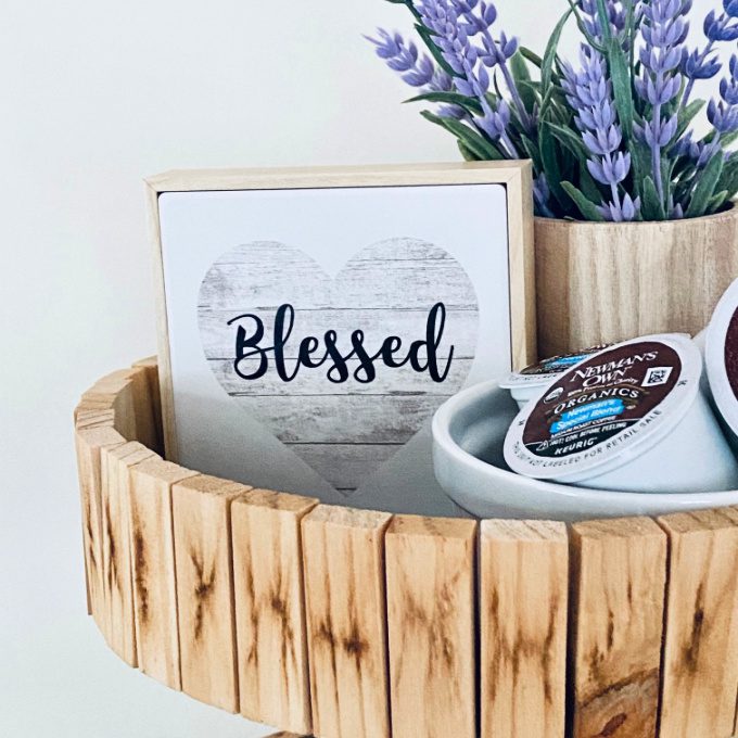 DIY Tiered Tray made from small wood blocks styled with a faux lavender plant, a small blessed sign, and coffee pods