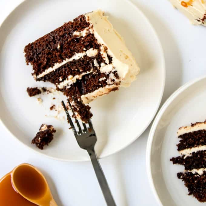 Top down view of chocolate caramel cake on a plate with a fork.