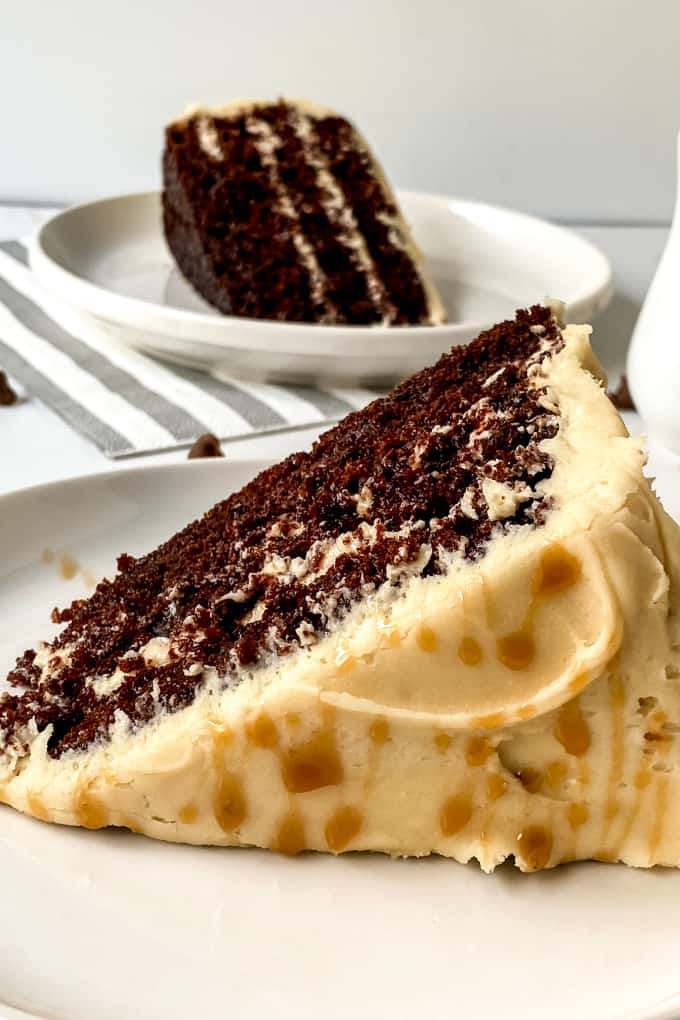 Two slices of chocolate & caramel cake drizzled with caramel sauce.
