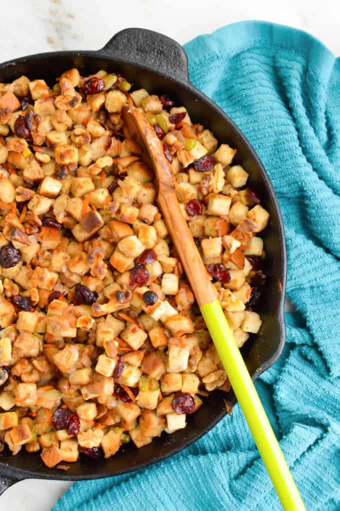 Cast iron skillet full of walnut cranberry stuffing.