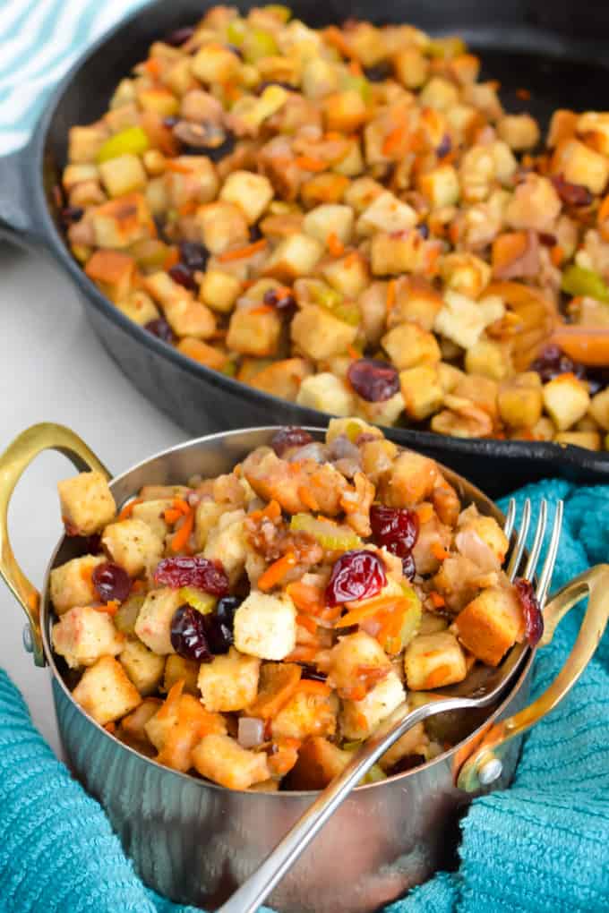 Close up of stuffing with cranberries and walnuts in a bowl.