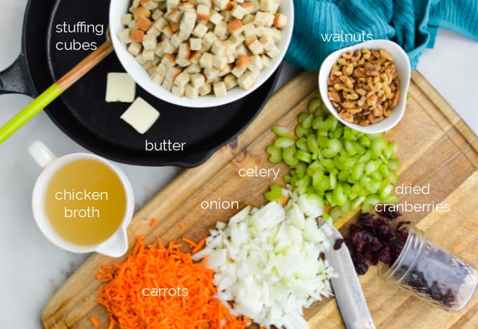 Walnut cranberry stuffing ingredients on a cutting board.