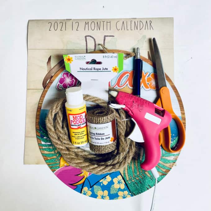 Supplies and materials to make a dollar tree pizza pan wreath.