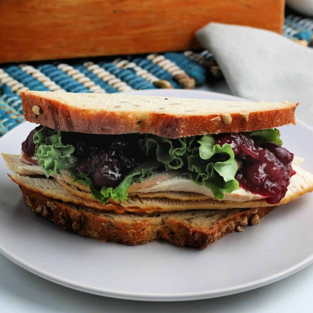 Leftover Thanskgiving turkey sandwich on a plate.