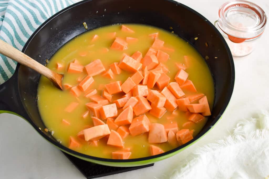 Sweet potatoes cooking in chicken broth.
