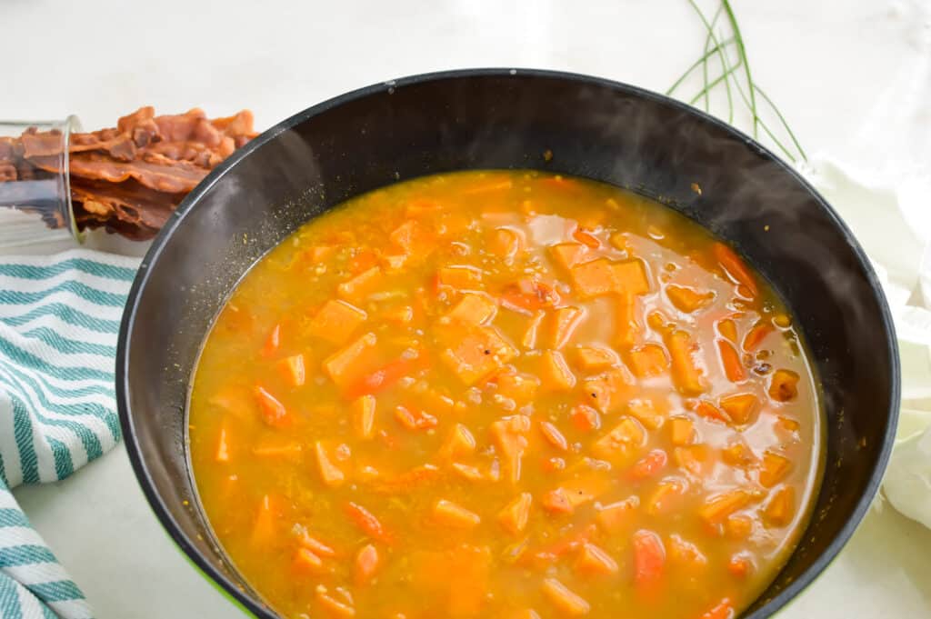 Sweet potatoes cooking in chicken broth.