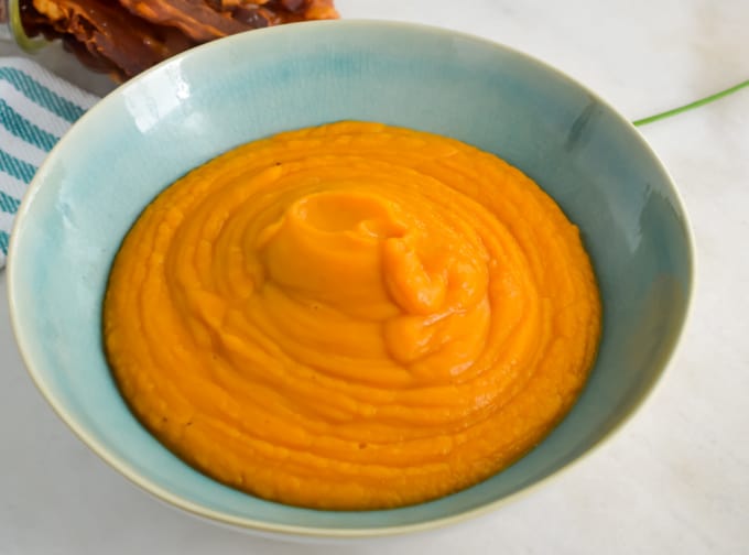 Close up of sweet potato soup in a bowl.