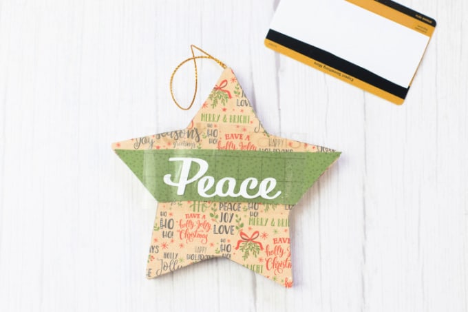 A finished paper mache ornament next to a rubbing tool.