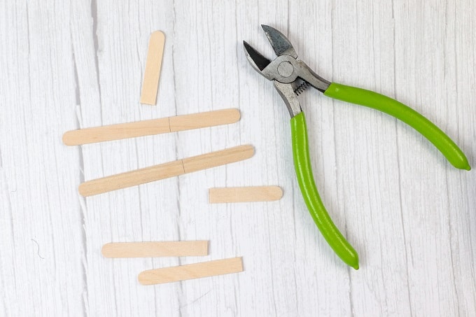 Top down view of floral wire cutters and popsicle sticks that have been cut.