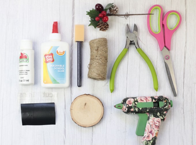 Materials and equipment needed to make a wood circle ornament.