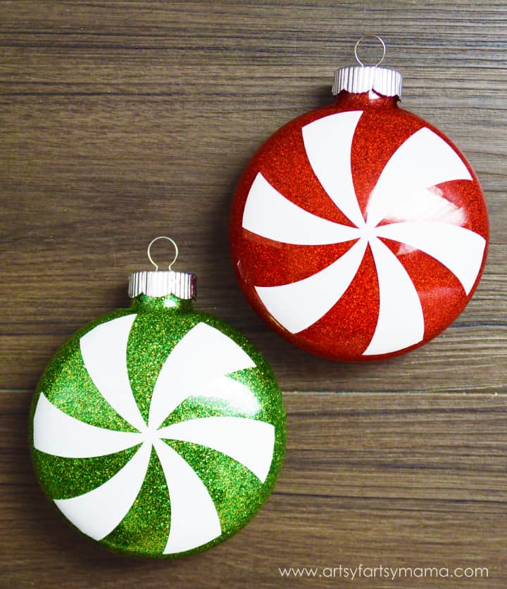 Two festive ornaments made to look like glittery peppermint candies.