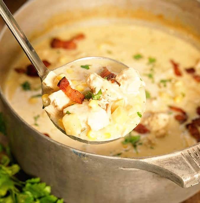 A ladel full of turkey corn chowder.