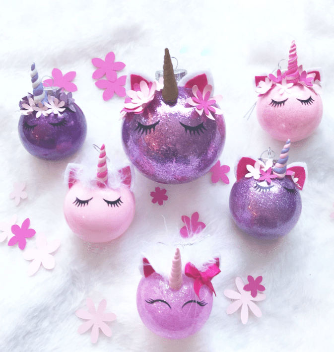 Pink and purple glitter ornaments made to look like unicorns.
