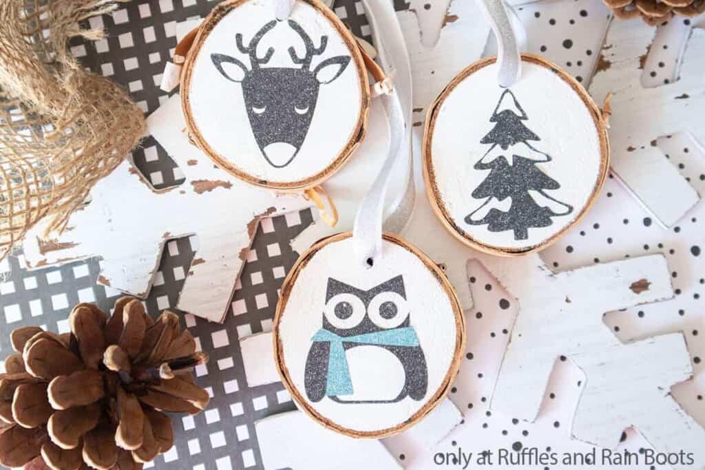 Top down image of Woodland animals on wood slice ornaments.