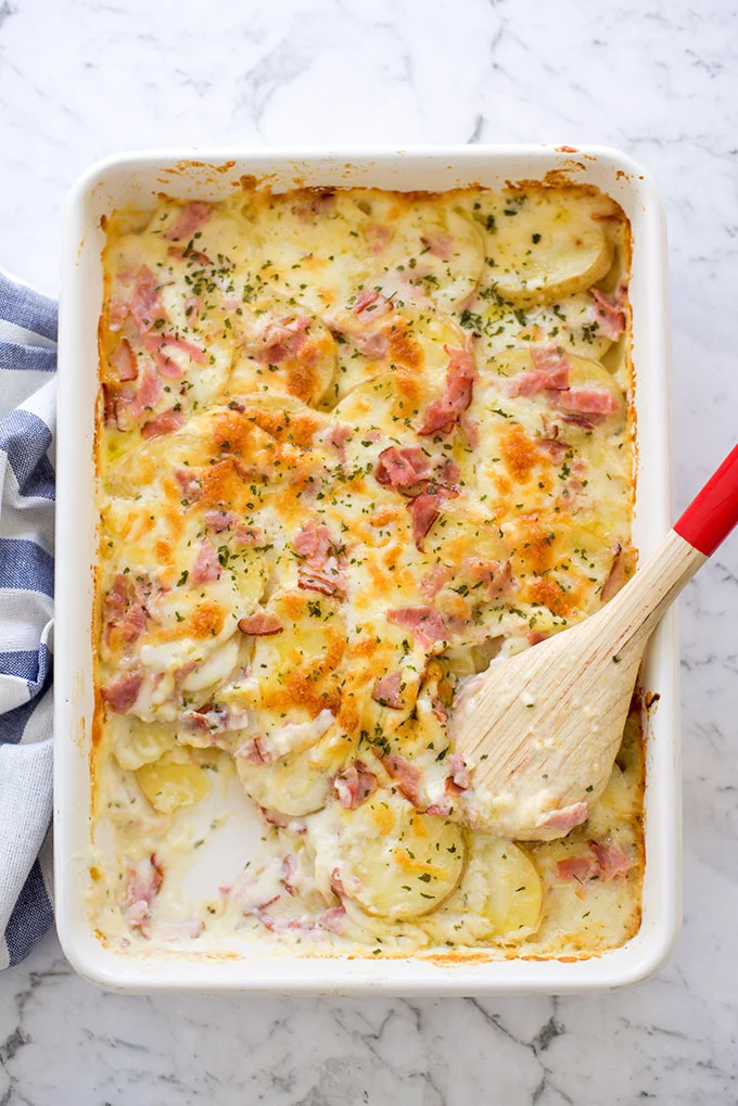 Top down image of scalloped potatoes and ham.