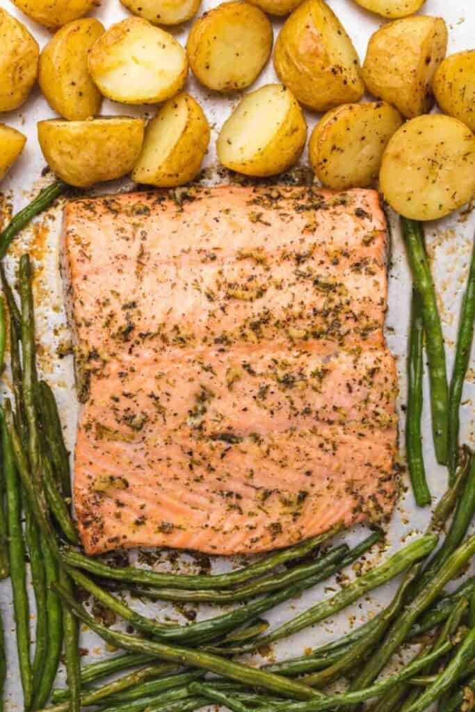 Baking sheet filled with sheet pan garlic butter salmon.