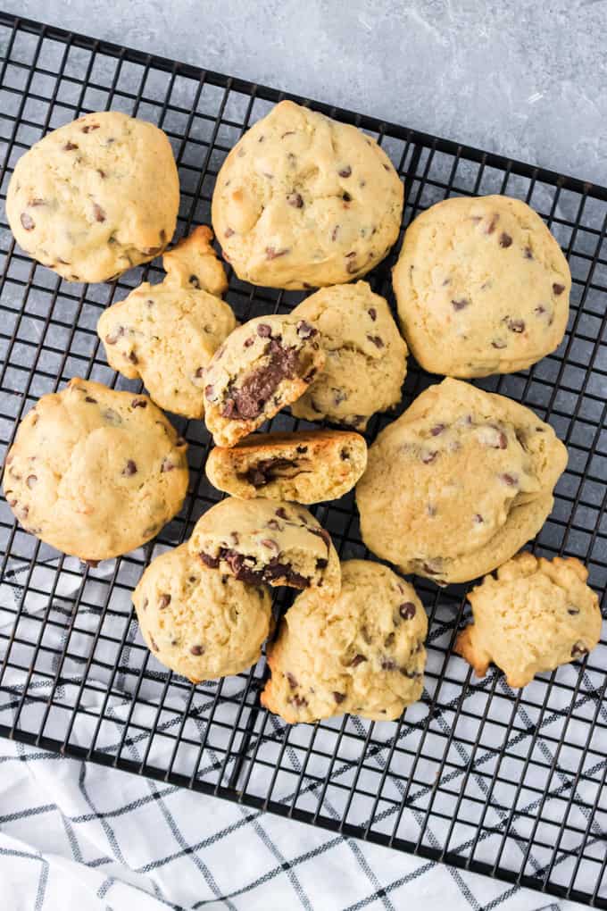 Nutella chocolate chip cookies in a pile on a wire rack.