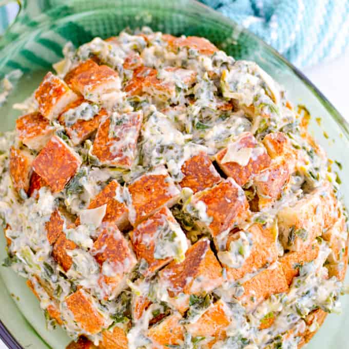 Loaf of bread stuffed with spinach and artichoke mixture.