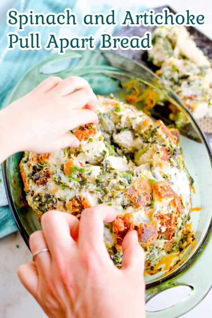 Hands pulling apart spinach and artichoke pull apart bread.