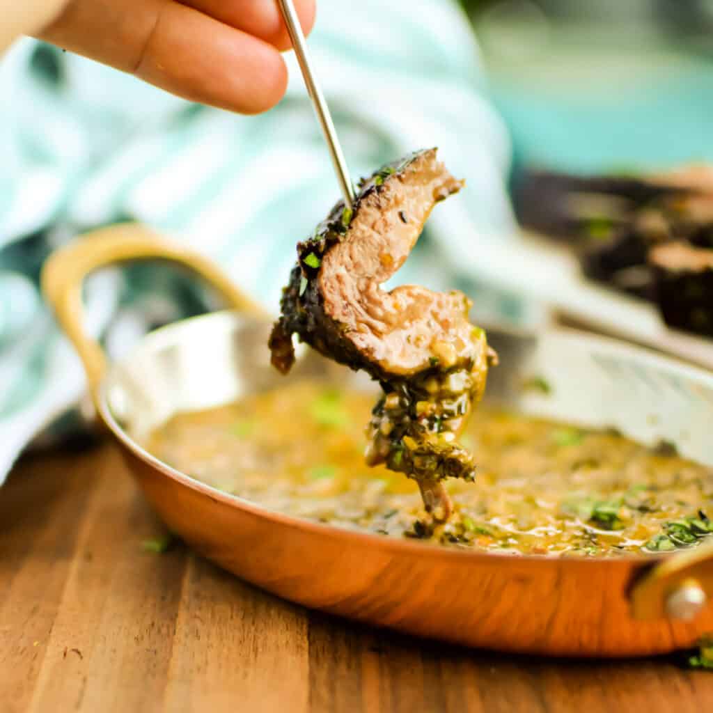 Steak with garlic cowboy butter dipping sauce on it.