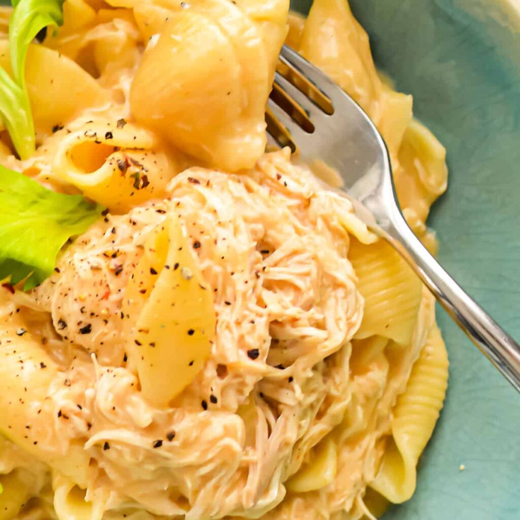 Easy Weeknight Recipes: Close up of Slow Cooker Buffalo Chicken Mac and Cheese in a bowl with a fork.