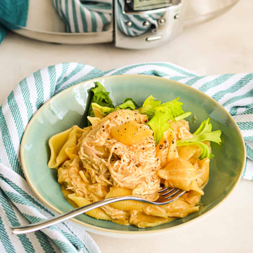 Close up of Buffalo Chicken Mac and Cheese in a bowl with a fork.