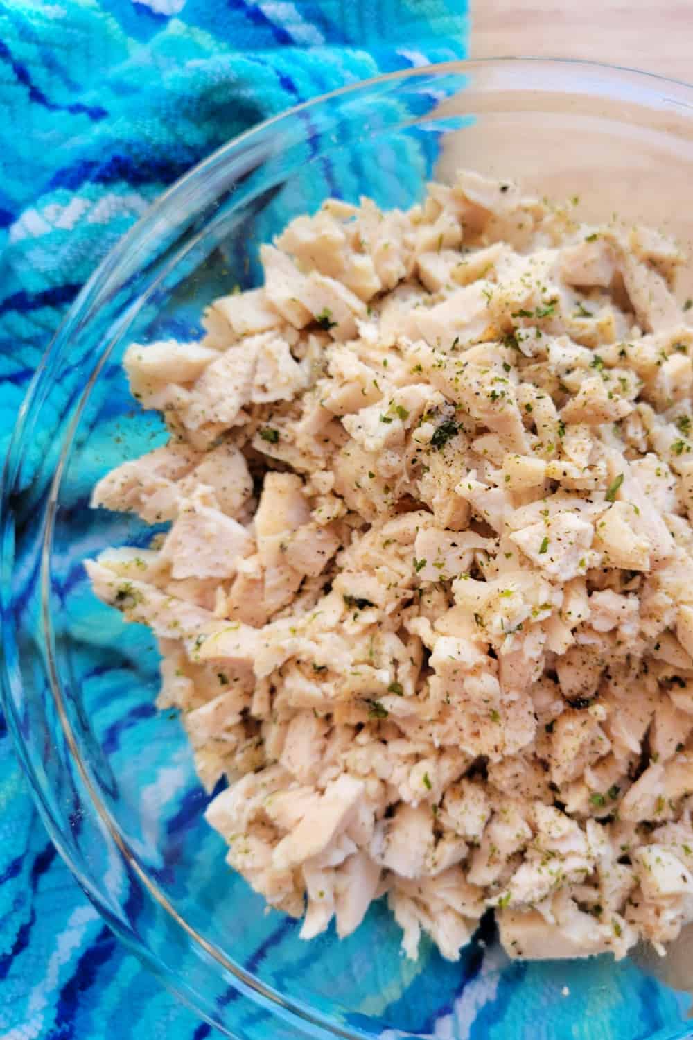 Close up of shredded chicken in a bowl.