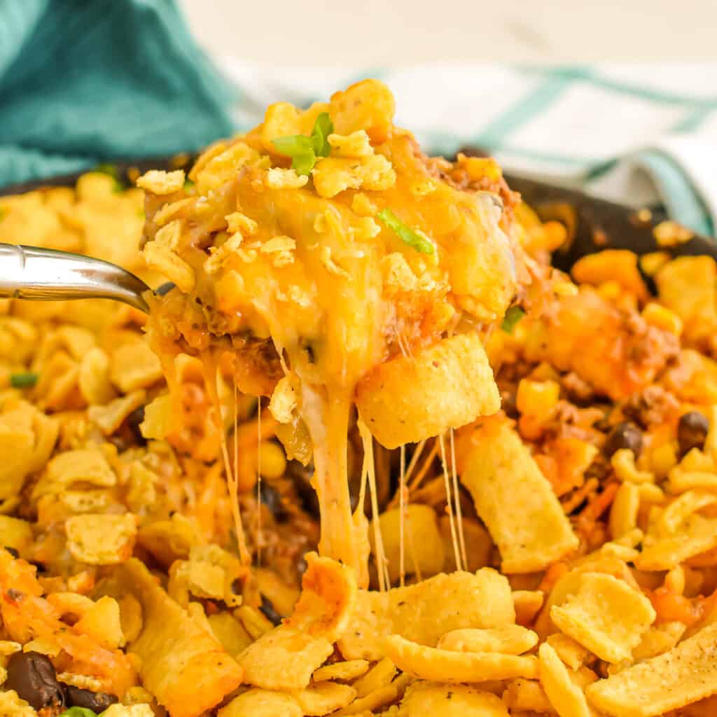 Close up of serving spoon full of Walking Taco Casserole.
