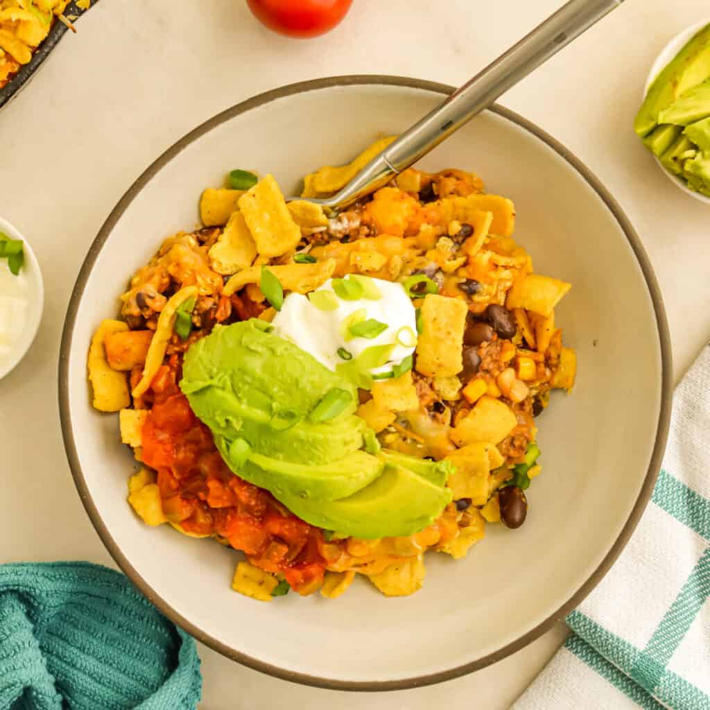 Top down view of Walking Taco Casserole in a bowl with a fork.