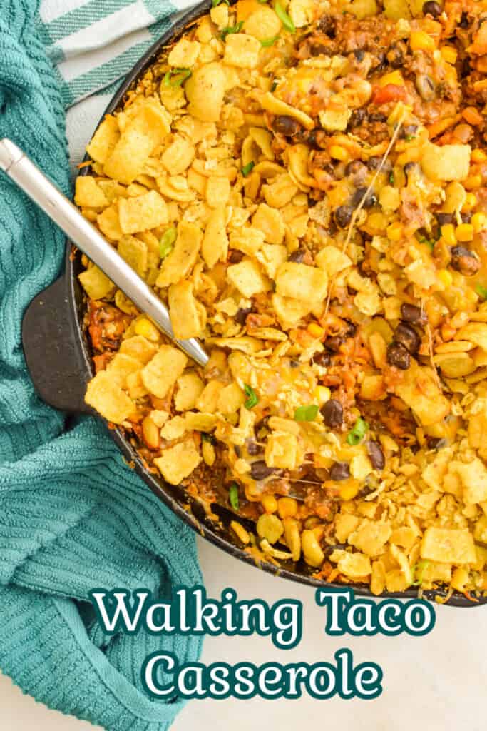 Top down view of Walking Taco Casserole topped with corn chips in a cast iron skillet.