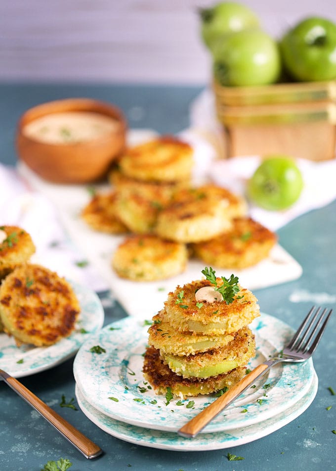 Fried Green Tomatoes stacked on top of one another with a fork.