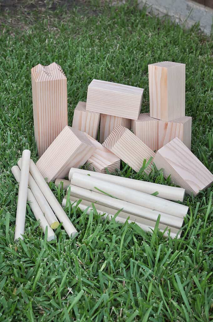 Kubb outdoor game - wooden blocks in the grass.