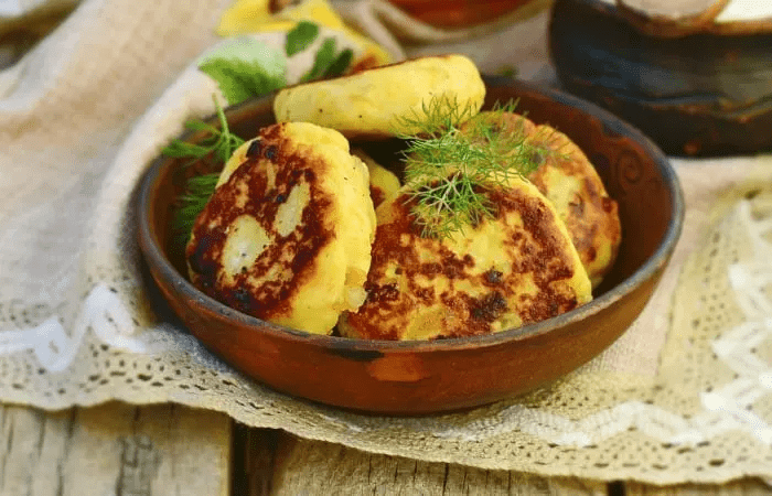 Onion Patties in a wooden bowl garnished with fresh dill.
