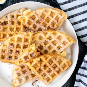 Close up of Churro Waffles on a white plate.