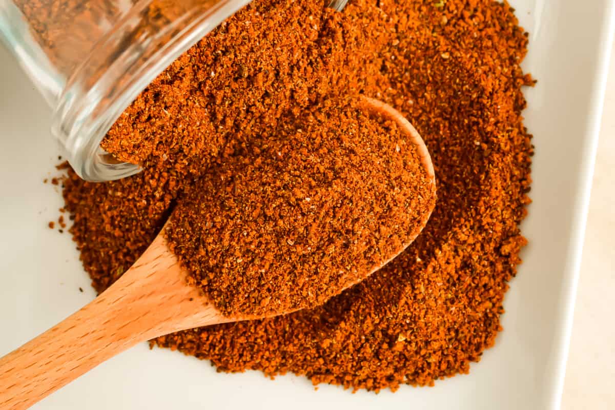 Flatlay image of Cowboy Steak Rub with a wooden spoon.