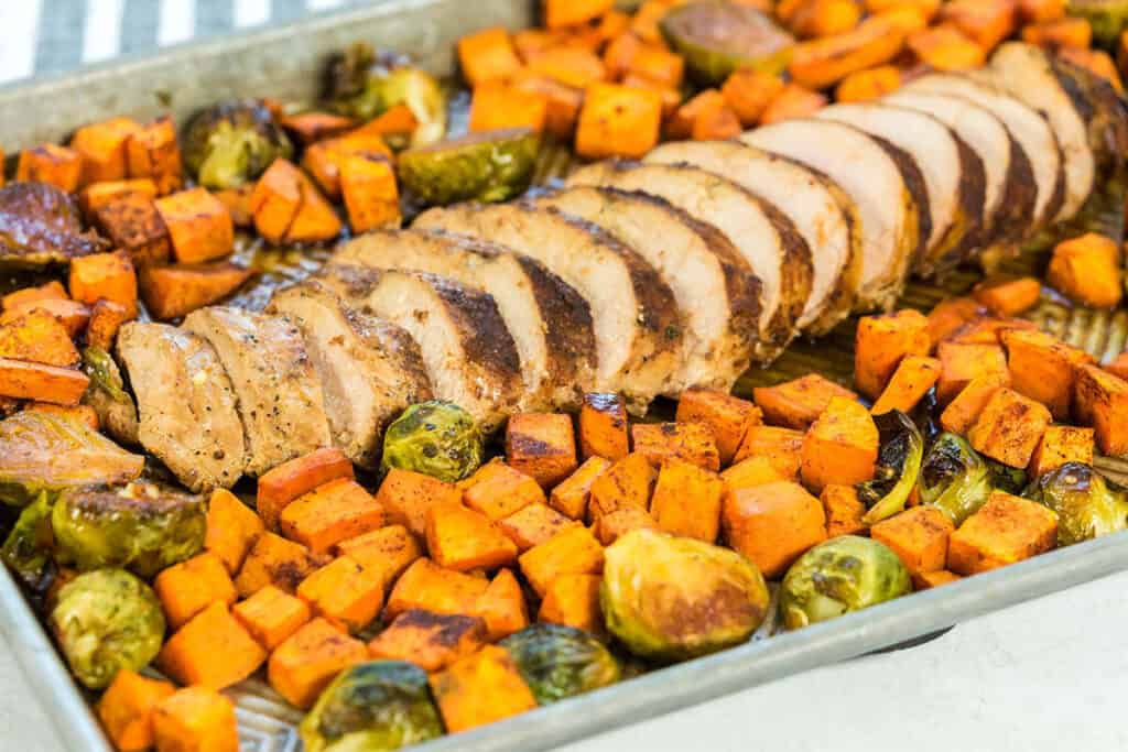 Roasted Pork Tenderloin and Sweet Potatoes on a sheet pan.
