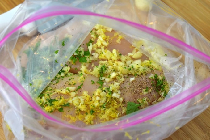 Chicken in a resealable bag with minced garlic, chopped parsley and zested lemon with salt and pepper.