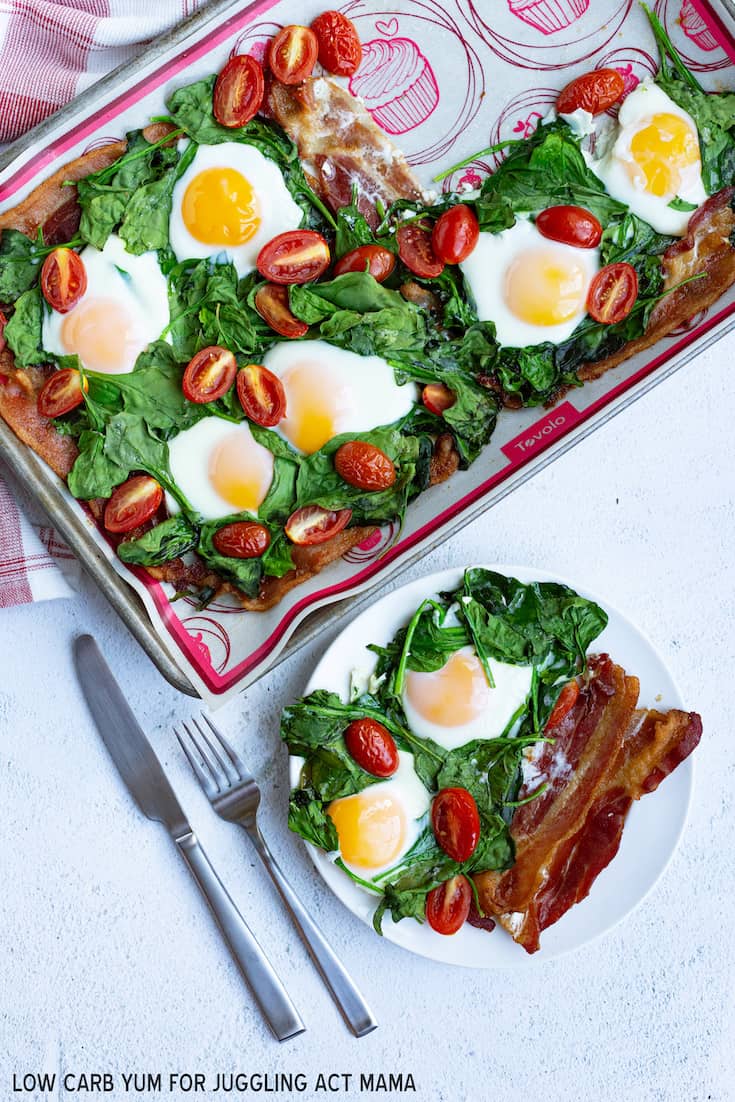 Sheet Pan Eggs and Bacon on a plate with silverware.