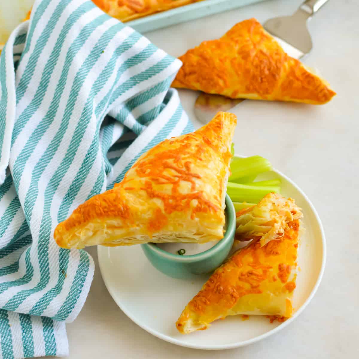Top down view of Buffalo Chicken Puff Pastry Pockets on a white plate.