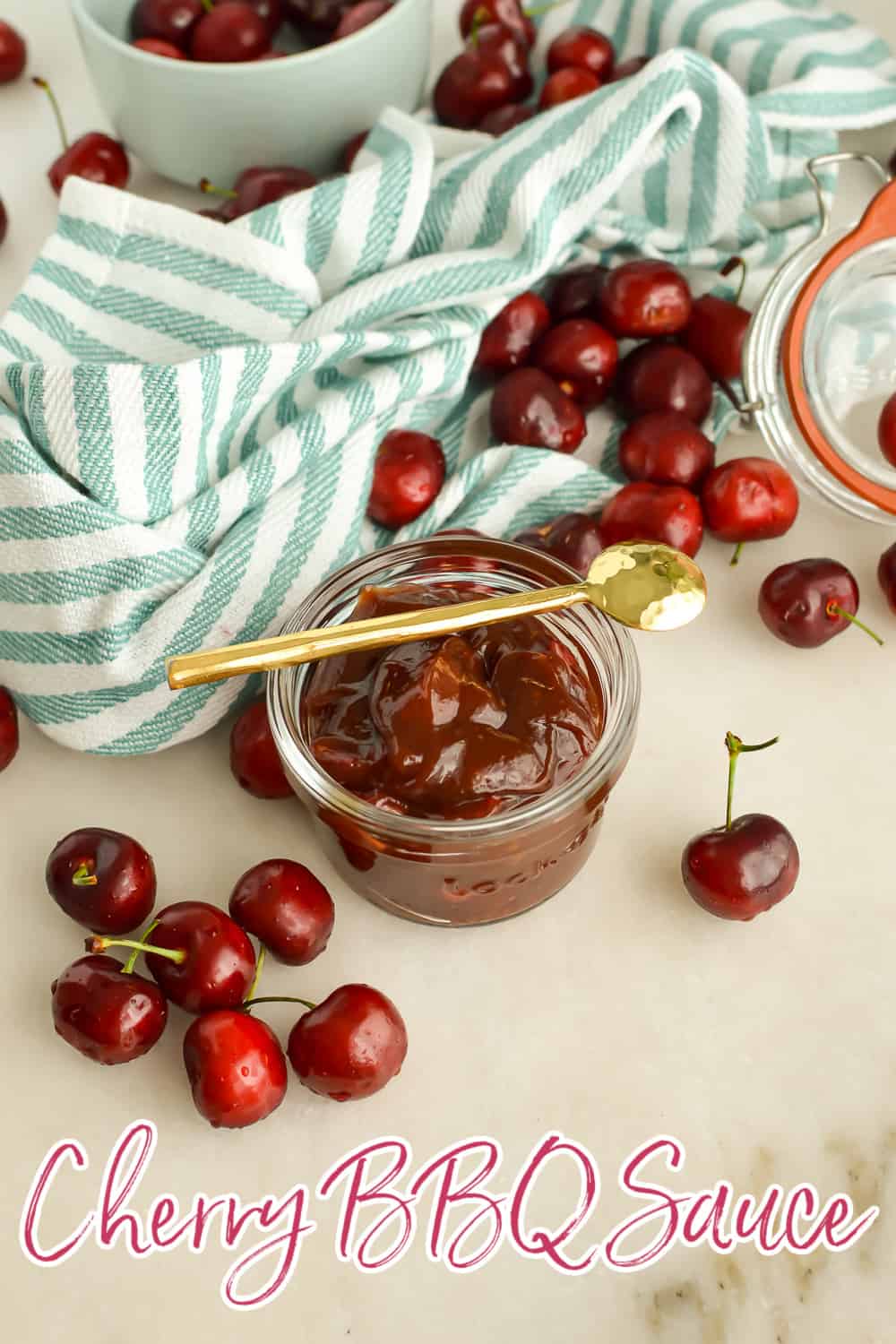 Jar of Cherry BBQ Sauce surrounded by fresh cherries pin image with text overlay.